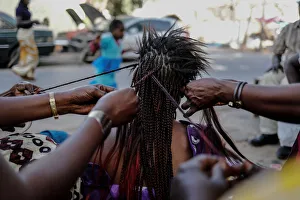 A woman gets her hair plaited at the Medina in the capital Dakar A woman gets her hair plaited at the Medina in the capital Dakar