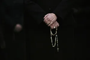 A woman holds her rosary during a Holy Week procession in Madrid A woman holds her rosary during a Holy Week procession in Madrid