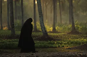 A woman from the Islamic sect An-Nadzir walks to an Eid al-Adha mass prayer at Mawang A woman from the Islamic sect An-Nadzir walks to an Eid al-Adha mass prayer at Mawang