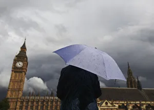 A woman looks towards dark clouds over the Houses of Parliament in central London A woman looks towards dark clouds over the Houses of Parliament in central London