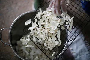 A woman manipulates dehydrated yucca at the Quinta Carmelita store A woman manipulates dehydrated yucca at the Quinta Carmelita store