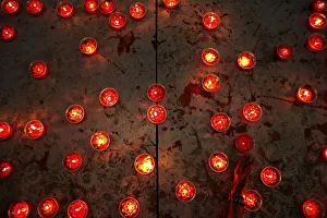 Woman places candle at a temple ahead of the Chinese Lunar New Year celebrations in Woman places candle at a temple ahead of the Chinese Lunar New Year celebrations in