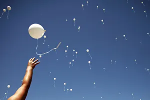 A woman releases a balloon into the air during the 20th anniversary of the closure A woman releases a balloon into the air during the 20th anniversary of the closure