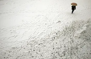 Woman walks with umbrella during snowfall in downtown Sofia Woman walks with umbrella during snowfall in downtown Sofia