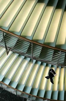 A worker at a hotel walks down a staircase in Tokyo A worker at a hotel walks down a staircase in Tokyo