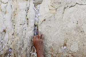 A worker removes notes from the cracks of the Western Wall in Jerusalems Old City A worker removes notes from the cracks of the Western Wall in Jerusalems Old City
