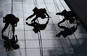 Workers clean the windows of a building in Quito Workers clean the windows of a building in Quito