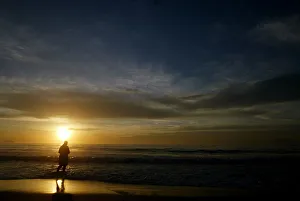 Worshipper tosses floral offering for Goddess of the sea, during sunrise on Copacabana Worshipper tosses floral offering for Goddess of the sea, during sunrise on Copacabana