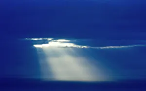 Sun poking through clouds at dusk over North Sea Shetland Sun poking through clouds at dusk over North Sea Shetland