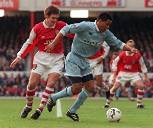 Coventrys John Salako holds off Adrian Clark during Premiership match at Highbury Coventrys John Salako holds off Adrian Clark during Premiership match at Highbury