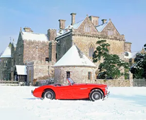 Austin Healey 100 in snow in front of Palace House Austin Healey 100 in snow in front of Palace House