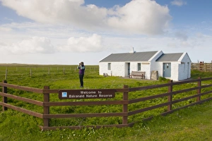 Birdwatcher beside visitor centre print