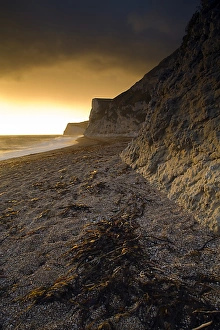 Durdle Door Beach Prints: View of beach and limestone sea cliffs at sunset