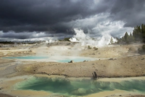 Yellowstone Geysers Prints: View of hotsprings with approaching stormclouds