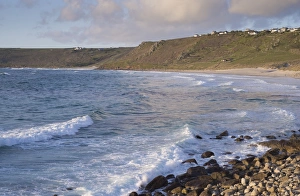 Sennen Cove Prints: View of waves and coastline in evening sunlight