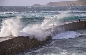 Cape Cornwall Prints: Waves breaking over harbour wall