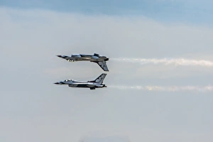 2 Thunderbird jets mirroring, one upside down 2 Thunderbird jets mirroring, one upside down