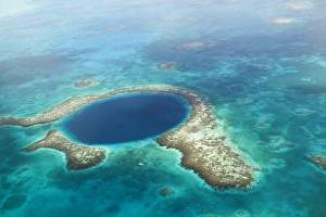 aerial view of Blue Hole, sailboat anchored nearby, Lighthouse Atoll, Belize aerial view of Blue Hole, sailboat anchored nearby, Lighthouse Atoll, Belize