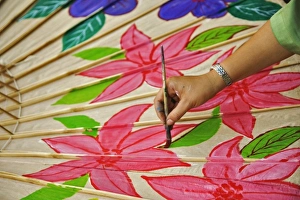 Artist hand painting decorative umbrella, Umbrella Making Center, Bo Sang, near Chiang Mai Artist hand painting decorative umbrella, Umbrella Making Center, Bo Sang, near Chiang Mai
