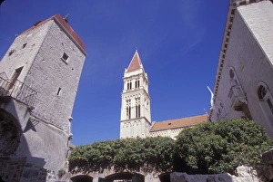 The belltower of the Cathedral of Saint Lobro is surrounded by other nearby buildings The belltower of the Cathedral of Saint Lobro is surrounded by other nearby buildings