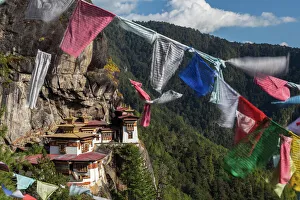 Bhutan, Paro. Prayer flags fluttering at the cliffs edge across from Taktsang Monastery Bhutan, Paro. Prayer flags fluttering at the cliffs edge across from Taktsang Monastery
