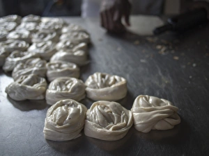 Bits of dougH are rolled into mounds Tto be cooked in Bangalore, Karnataka, India Bits of dougH are rolled into mounds Tto be cooked in Bangalore, Karnataka, India