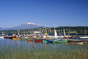 Boats docked at a marina with Villarica volcano in Villarica, Chile Boats docked at a marina with Villarica volcano in Villarica, Chile