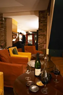 Bottle on a table with wine glasses and decanter in the wine bar Le Cafe du Passage in Bottle on a table with wine glasses and decanter in the wine bar Le Cafe du Passage in