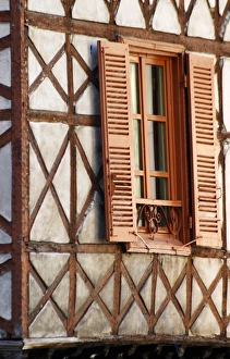 A building in the town with old half timber facade and wooden shutters A building in the town with old half timber facade and wooden shutters
