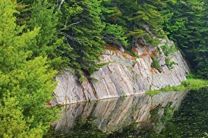 Canada, Ontario, Killarney District. Granite reflected in water Canada, Ontario, Killarney District. Granite reflected in water