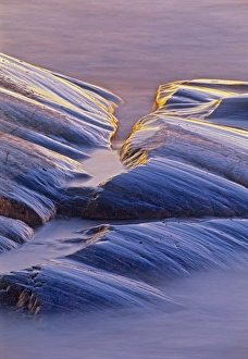 Canada, Ontario, Neys Provincial Park. Rock at edge of Lake Superior at sunset. Credit as Canada, Ontario, Neys Provincial Park. Rock at edge of Lake Superior at sunset. Credit as