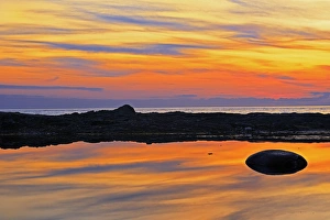 Canada, Quebec, Gulf of St. Lawrence. Reflection on water at sunset Canada, Quebec, Gulf of St. Lawrence. Reflection on water at sunset