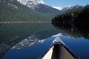 canoe on a placid lake along the eastern side of Glacier National Park, Montana canoe on a placid lake along the eastern side of Glacier National Park, Montana