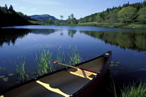A canoe rests on the shore of Little Long Pond at Acadia National Park, Maine A canoe rests on the shore of Little Long Pond at Acadia National Park, Maine