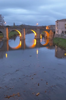 Carcassonne. Languedoc. The old bridge across the Aude river. Illuminated in early morning Carcassonne. Languedoc. The old bridge across the Aude river. Illuminated in early morning