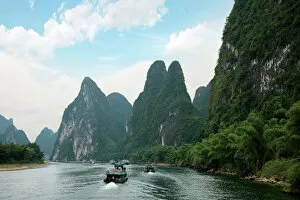 Images Dated 18th May 2010: China, Guilin, Li River, River boats line the way along the River with its dramatic mountains
