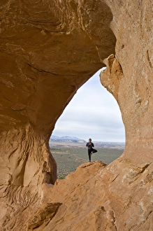 Climbing guide with Moab Desert Adventures, does yoga on Looking Glass Rock, near Moab Climbing guide with Moab Desert Adventures, does yoga on Looking Glass Rock, near Moab