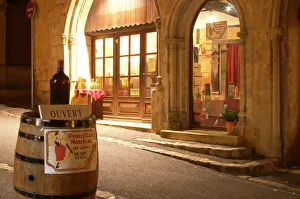 Cobble stone street in the old town with a wine shop, a wine barrel on the street Cobble stone street in the old town with a wine shop, a wine barrel on the street