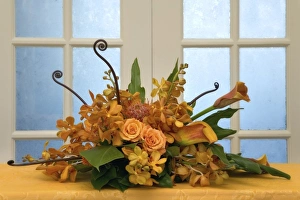 Colorful flower arrangement on table in front of door Colorful flower arrangement on table in front of door