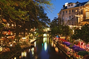 Colorful umbrellas of outdoor cafe at dusk along River Walk, San Antonio River, San Antonio, Texas Colorful umbrellas of outdoor cafe at dusk along River Walk, San Antonio River, San Antonio, Texas