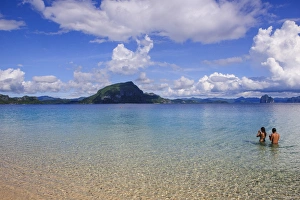 Couple standing in the clear waters of the Bacuit archipelago, Palawan , Philippines Couple standing in the clear waters of the Bacuit archipelago, Palawan , Philippines