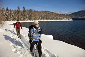 Cross country skiing along Lake McDonald in Glacier National Park in Montana (MR) Cross country skiing along Lake McDonald in Glacier National Park in Montana (MR)