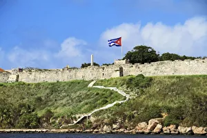 Cuba, Havana. Fortress wall and Cuban flag at San Carlos de la Cabana fortress in Cuba, Havana. Fortress wall and Cuban flag at San Carlos de la Cabana fortress in