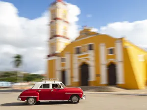 Cuba, Remedios, classic red car in front of Cathedral Cuba, Remedios, classic red car in front of Cathedral