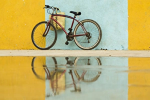 Cuba, Trinidad. Bicycle and reflection against yellow and blue walls Cuba, Trinidad. Bicycle and reflection against yellow and blue walls