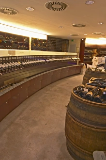 A curved display of bottles and a barrel used to present bottles The Lavinia wine shop in A curved display of bottles and a barrel used to present bottles The Lavinia wine shop in