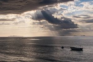 Dramatic light over a little boat, Mamanucas islands, Fiji, South Pacific Dramatic light over a little boat, Mamanucas islands, Fiji, South Pacific