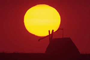 Draw well and reed cottage in puszta at Sunrise, National Park Lake Neusiedl, Burgenland Draw well and reed cottage in puszta at Sunrise, National Park Lake Neusiedl, Burgenland