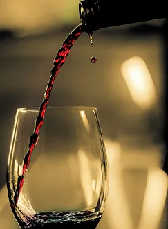 One drop shows as red wine is poured into glass One drop shows as red wine is poured into glass