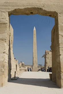 Egypt, Luxor. The obelisk at Karnak Temple rises tall above visitors to the ancient ruins Egypt, Luxor. The obelisk at Karnak Temple rises tall above visitors to the ancient ruins